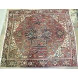 A large Persian carpet, cut and joined across the centre, 340 x 298cm.