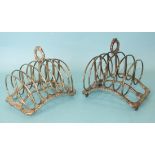 A pair of early-19th century six-division toast racks of arched gadrooned form on shell and tab