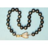 A single-strand black pearl necklace composed of twenty-eight black cultured South Sea pearls,
