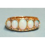 A Victorian five-stone opal ring, the graduated oval opals with diamond points, in 18ct gold