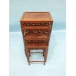 A nest of four carved hardwood Oriental graduated tables, each frieze carved with birds and