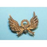 A Victorian gold brooch in the form of wings and bow set seed pearls, (with hook for pendant at