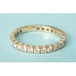 A diamond eternity ring claw-set twenty-eight brilliant-cut diamonds, in unmarked yellow and white