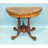 A mid-Victorian walnut card table, the circular fold-over top inlaid with boxwood, raised on four