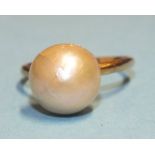 A cultured pearl ring, the 9mm pearl, (cracked), on plain gold shank, (tests as 18ct approximately),