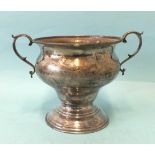 A two-handled trophy cup of bellied form, on circular base, with engraved decoration, 12cm high,