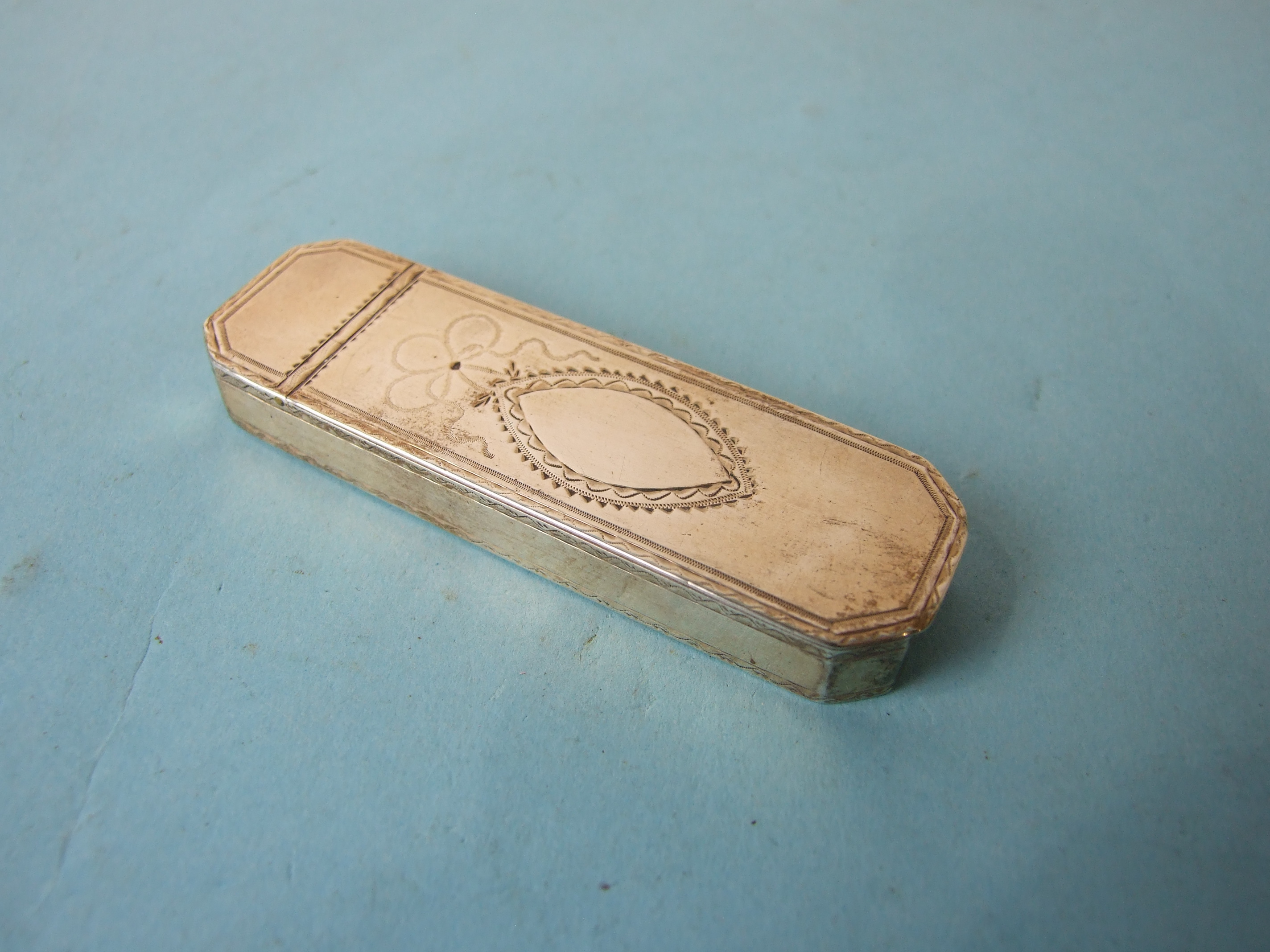 A Samuel Pemberton tooth-pick box of typical rounded oblong shape, with hinged bright cut lid,