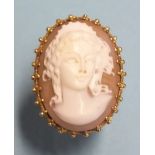 A large 9ct gold ring set a shell cameo of a young woman, size K, 9.4g.