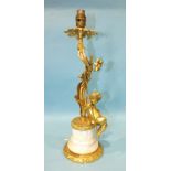 A 20th century gilt brass and marble table lamp of foliate form, with a cherub seated on the