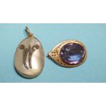 A brooch of teardrop shape, with pierced decoration set oval amethyst and a gold and mother-of-pearl