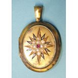 A Victorian gold oval locket, one side set with a demi-pearl-set star, centred by a ruby, (two