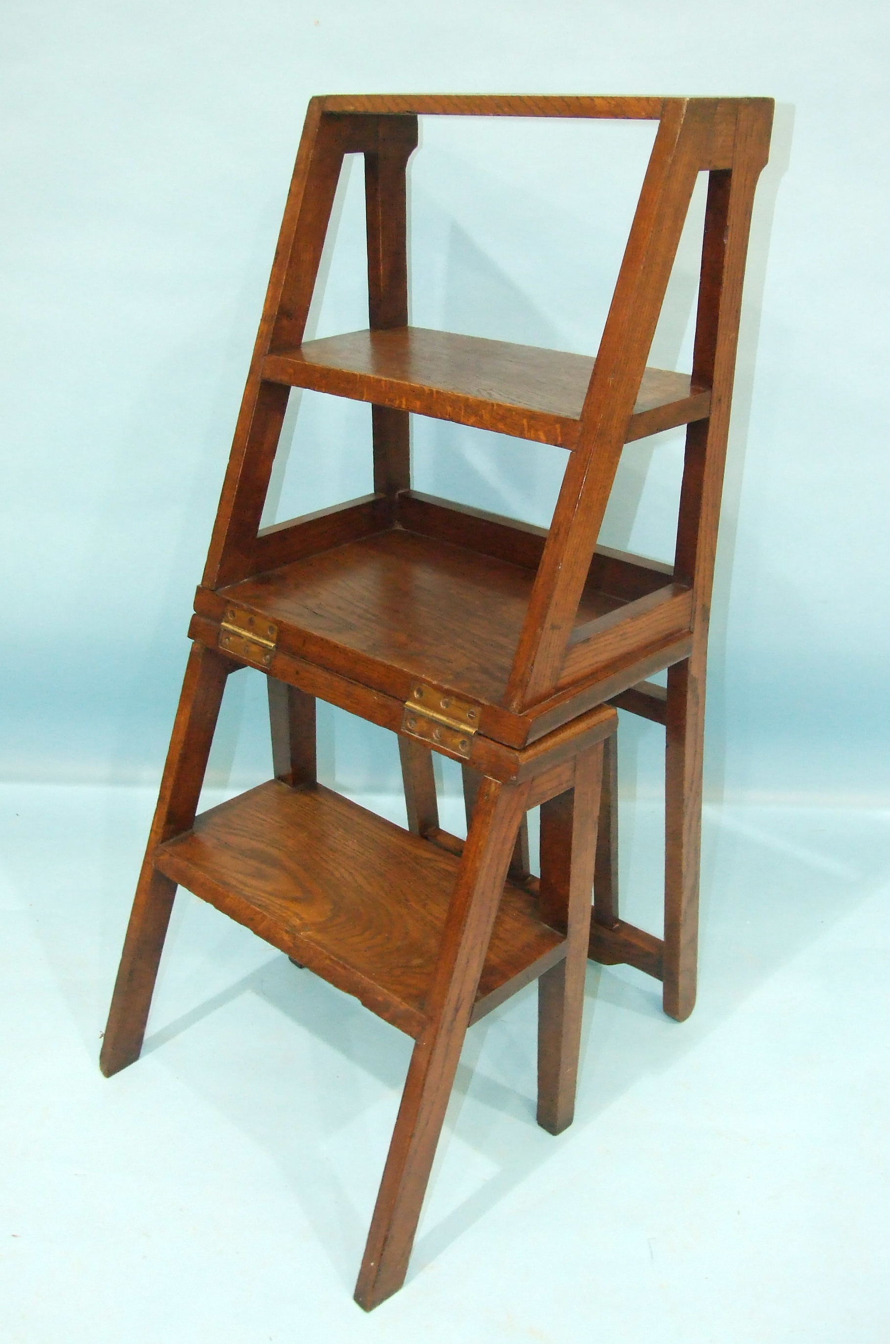 A late-19th century oak metamorphic chair/library steps.