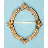 A Victorian gold brooch frame set demi-pearls of oval form, with four pearl triplets, possibly for a