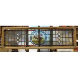 A late-19th/early-20th century leaded and stained-glass panel, with central circular pane