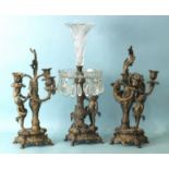 A late-19th century bronzed metal and cut-glass epergne supported by a vase column and putti, on