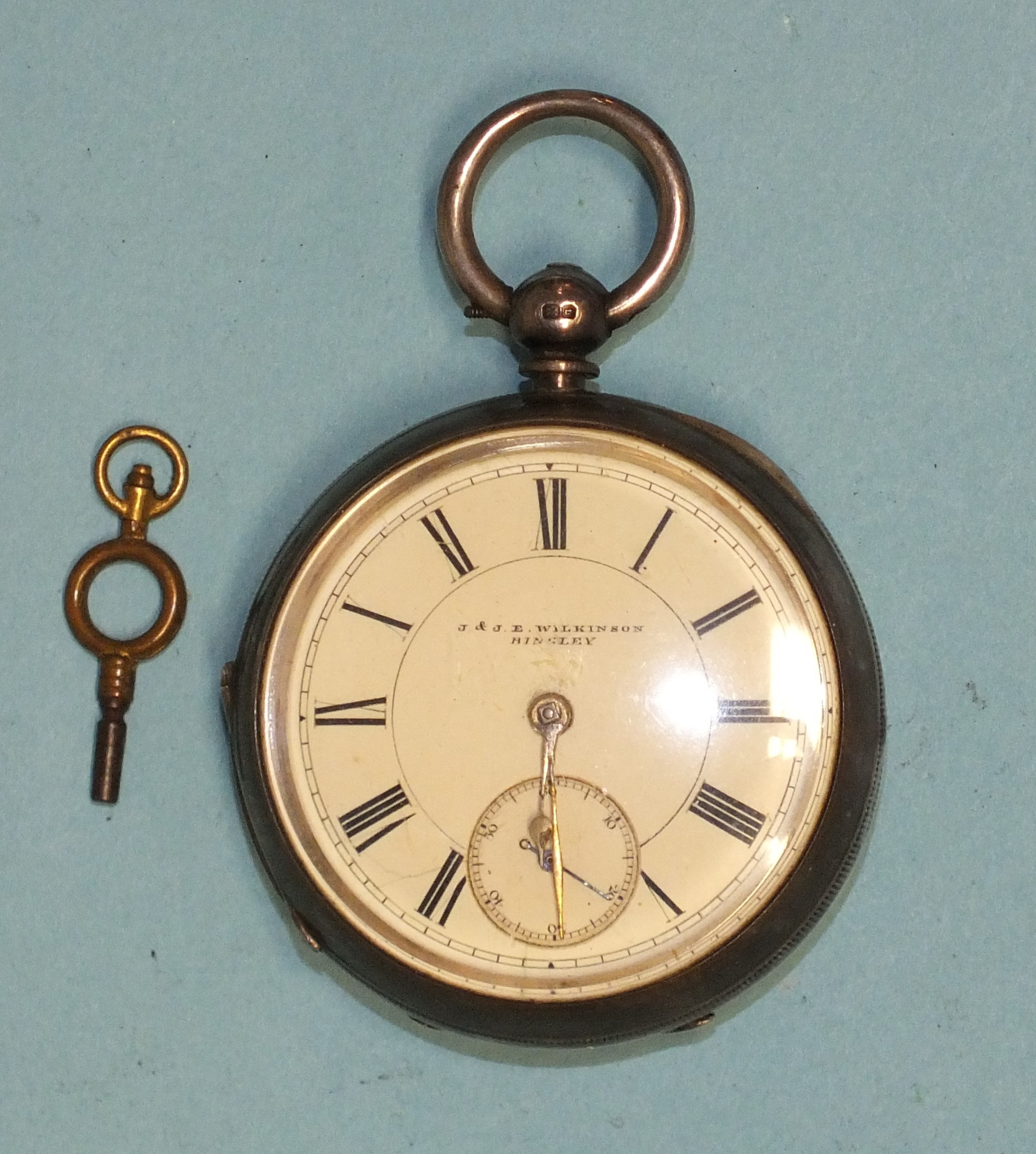 J & JE Wilkinson, Bingley, a silver-cased open-face key-wind pocket watch, the white enamel dial