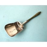 A George III silver caddy spoon of shovel form, with green-stained turned wood handle, maker William
