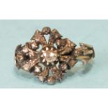 A late 18th century diamond cluster ring, the central irregular rose-cut diamond in foil-back cut