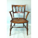 A 19th century elm and fruitwood kitchen armchair with balustraded back and solid seat, on turned