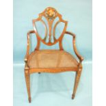 A reproduction Hepplewhite-style painted mahogany shield-back armchair with caned seat, on square
