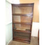 A Globe Wernicke oak five-section bookcase, with glazed up-and-over doors, on base, 87cm wide, 172cm