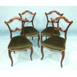 A set of four Victorian rosewood dining chairs, each with carved and foliate back and  cabriole