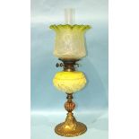 A Victorian brass and copper oil lamp with moulded pale green glass reservoir and etched glass