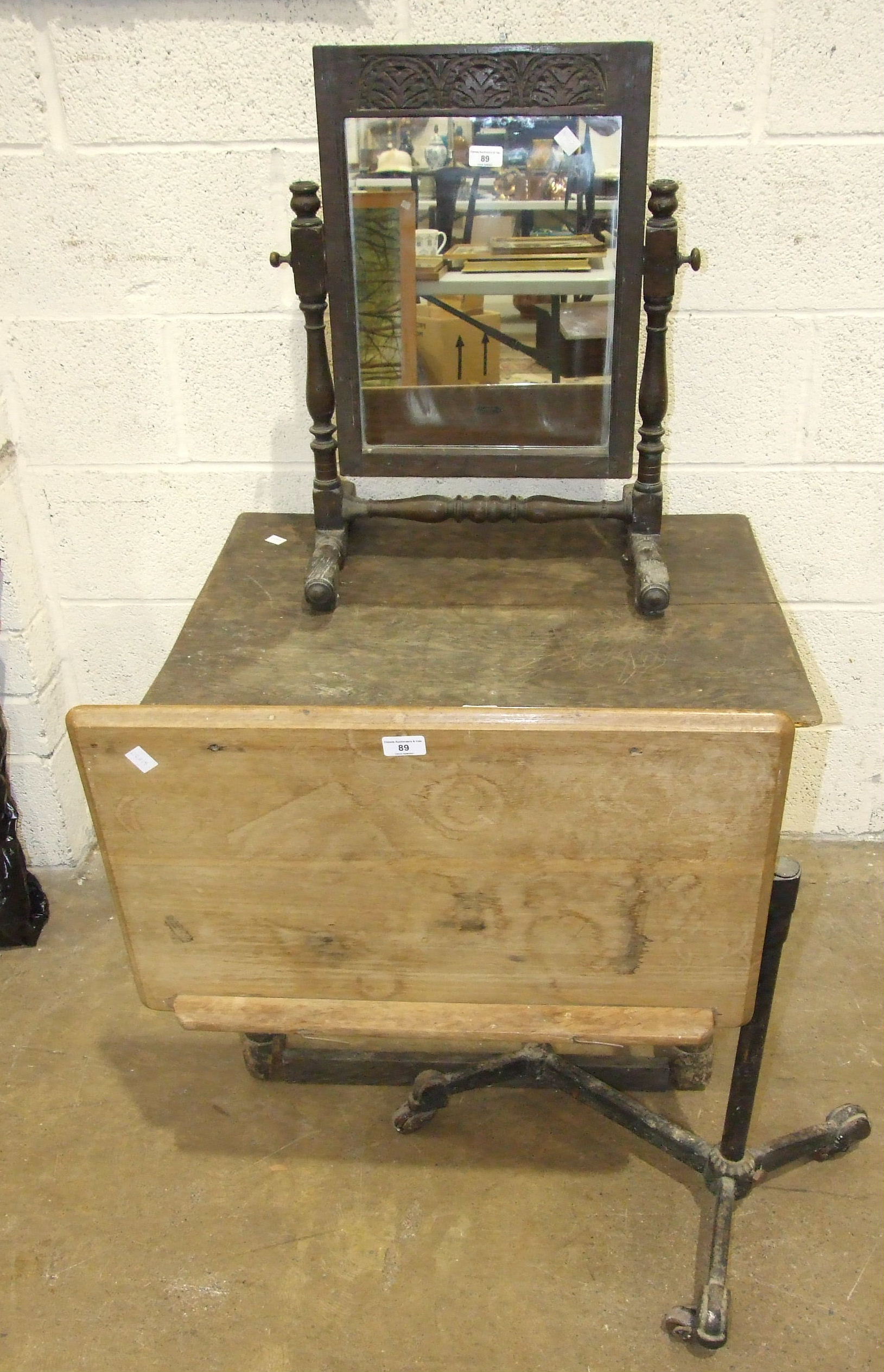 An oak and cast-iron adjustable bed table labelled Harrods Ltd, London SW, an oak dressing glass,