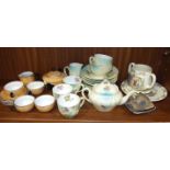 A Continental doll's tea service, comprising four cups and saucers, plate, teapot, milk jug and
