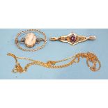 A 9ct gold brooch set shell cameo, a 9ct gold brooch set garnet and seed pearls and a 9ct gold