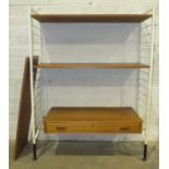 A Ladderax shelf unit, the white metal supports with drawer and three shelves, 90cm wide, 144cm