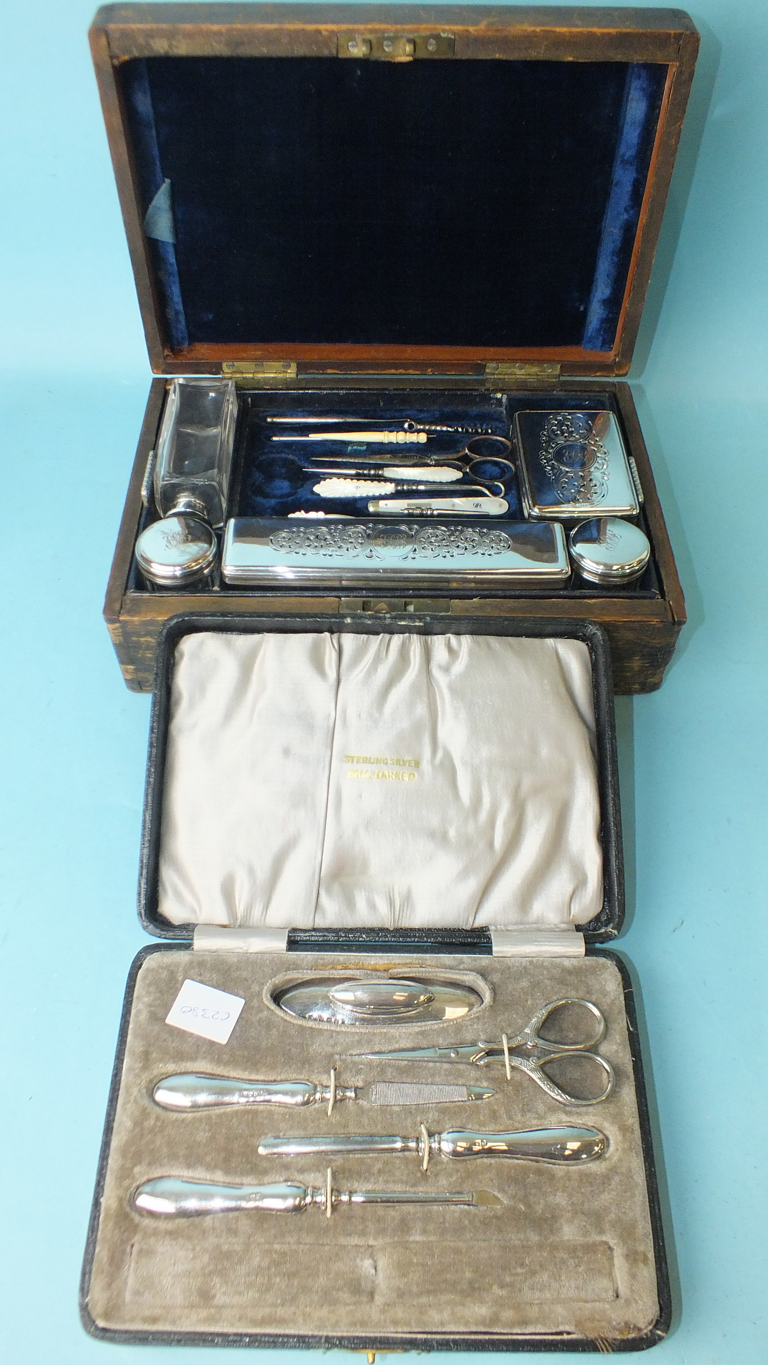 A silver-handled manicure set in fitted box, (scissors replaced by a steel pair), Birmingham 1919