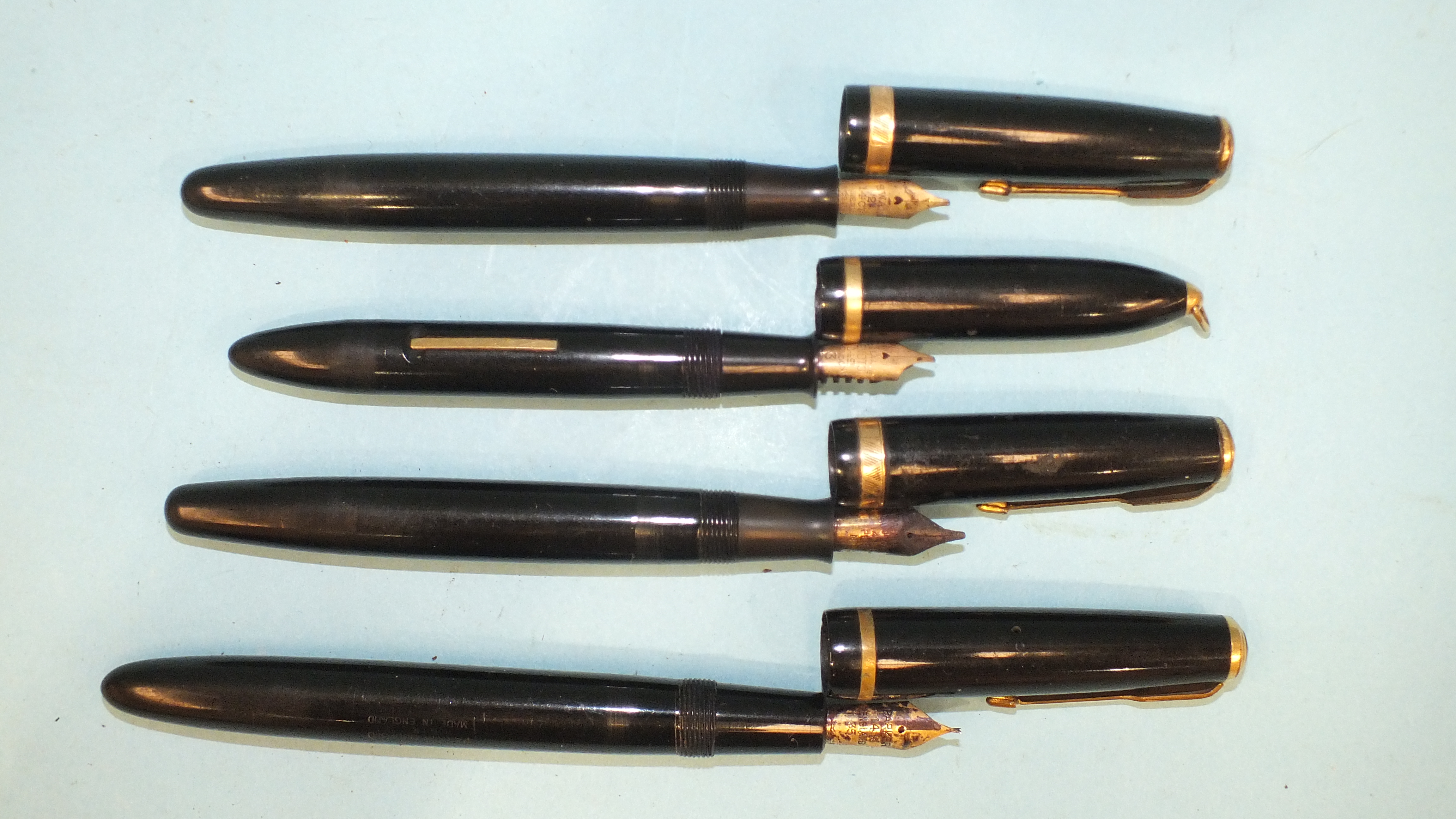 A collection of three Parker Duofold fountain pens and a Sheaffer fountain pen, (4).