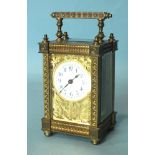 A late-19th/early-20th century brass carriage timepiece with ornate gorge case, the face with cut