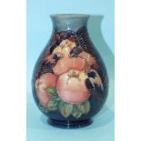 A modern Moorcroft baluster-shaped vase with pomegranate, berries and birds tubelined decoration,