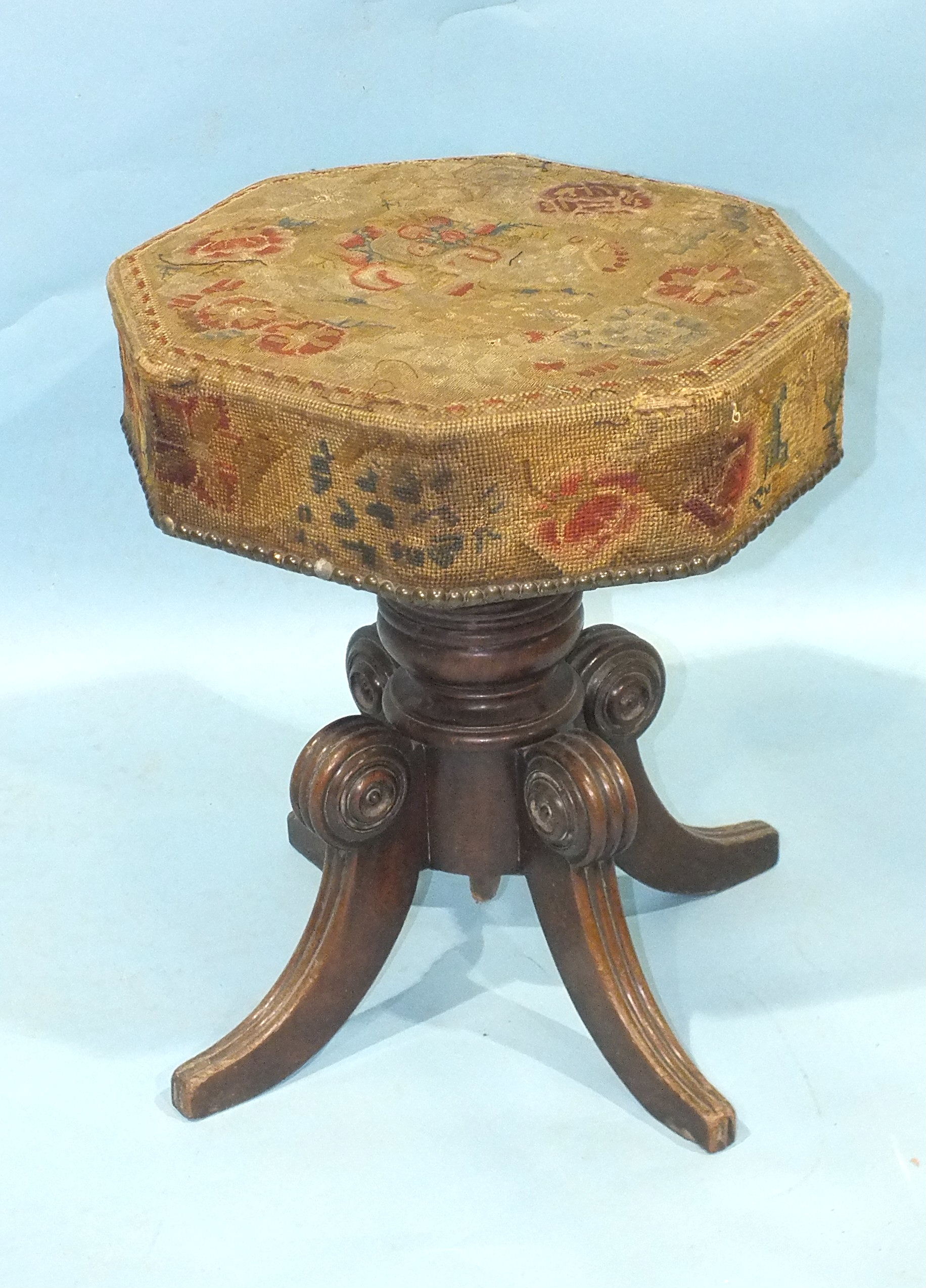 An early-19th century mahogany music stool, the revolving adjustable seat, with original
