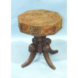 An early-19th century mahogany music stool, the revolving adjustable seat, with original