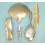 A Continental silver-backed hand mirror, clothes brush, hair brush and comb, marked .835, (4).