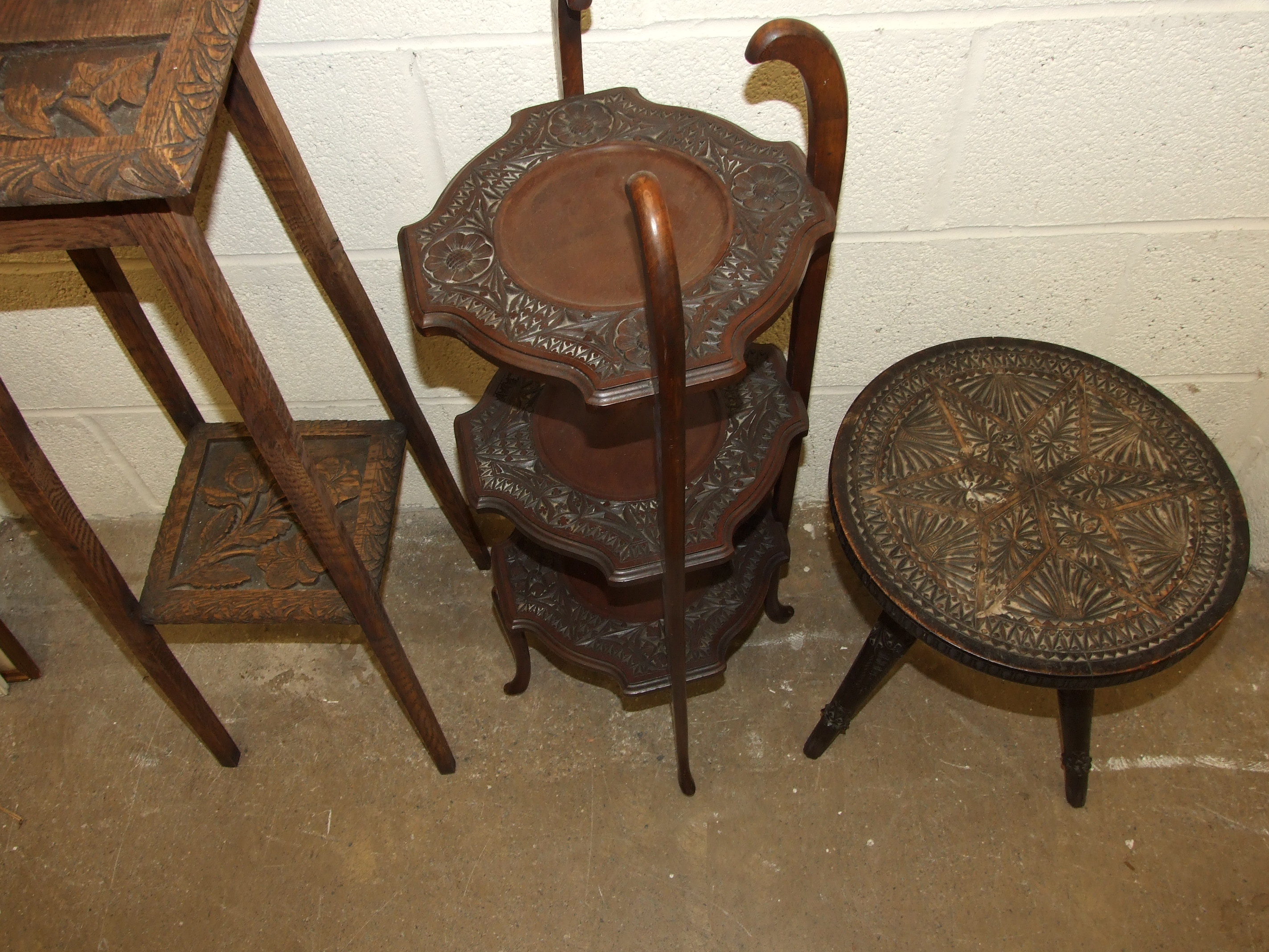 A carved wood three-legged table, a three-tier cake stand and a plant stand, (3). - Image 2 of 2