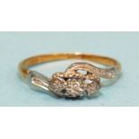 An 18ct yellow and white gold crossover ring set three small 8/8-cut diamonds, size M½, 2.1g.