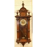 A late-Victorian walnut-cased Vienna-style wall clock, the pedimented case painted to simulate