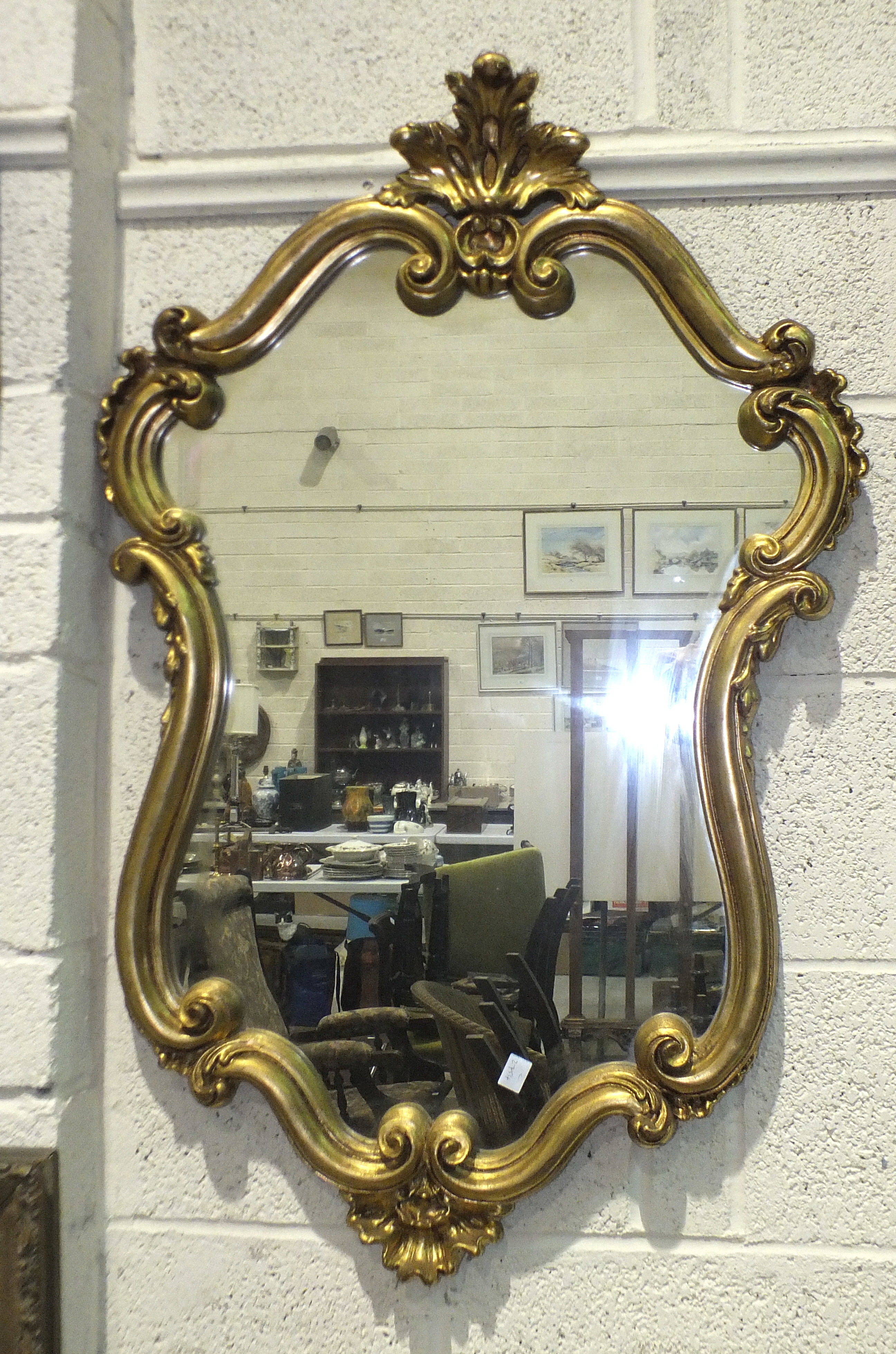 A modern gilt scrolling frame wall mirror, 98 x 63cm, a wool-work picture and an oleograph