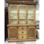 A Victorian pitch pine dresser, the moulded cornice above three glazed doors, the lower part with