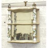 A Continental painted wood three-tier mirrored-back wall shelf, the shelves separated by floral-