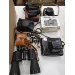 A Zenit-E 35mm camera in case, a Halina camera, other cameras, a pair of Milo 7 x 18 field glasses