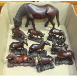 An Oriental carved hardwood model of a horse grazing, 14cm high and nine other carved similar