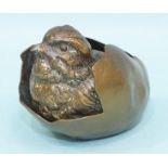 An Austrian cold-painted bronze chick emerging from an egg, marked Geschutz, 5cm high, 6cm long.