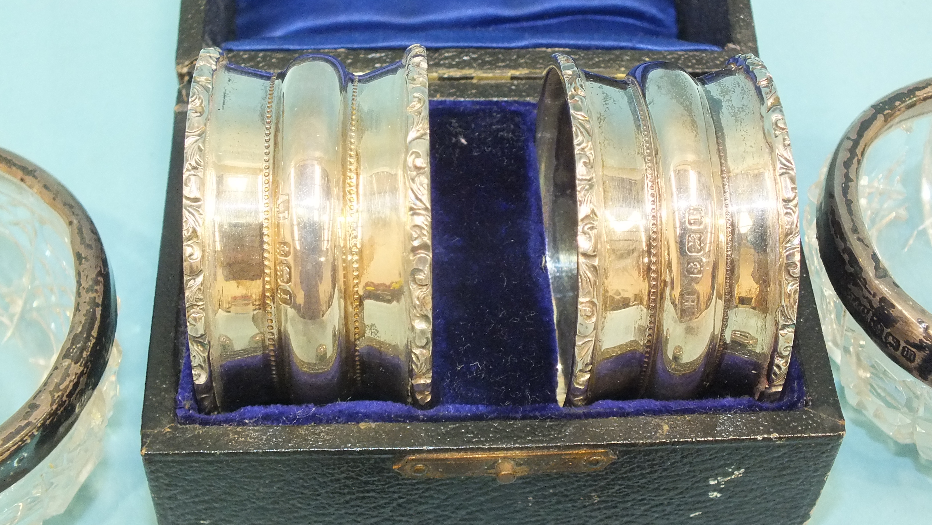 A pair of cased silver napkin rings, Birmingham 1910, a pair of silver-mounted glass salts, a silver - Image 2 of 2