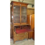 A Georgian-style mahogany small secretaire with fitted writing drawer above three cockbeaded