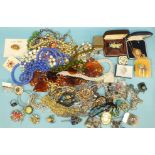 A silver heraldic brooch and a quantity of costume jewellery, etc.
